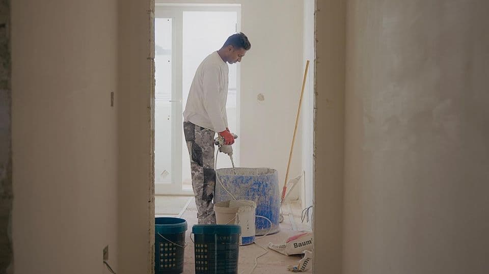 Plasterer preparing internal walls for a smooth finish