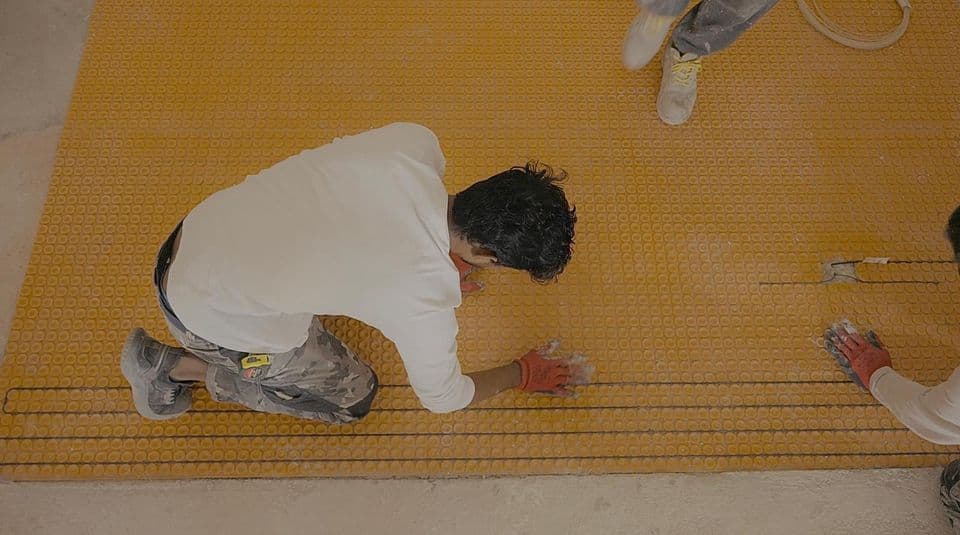 Installing underfloor heating pipes before screeding