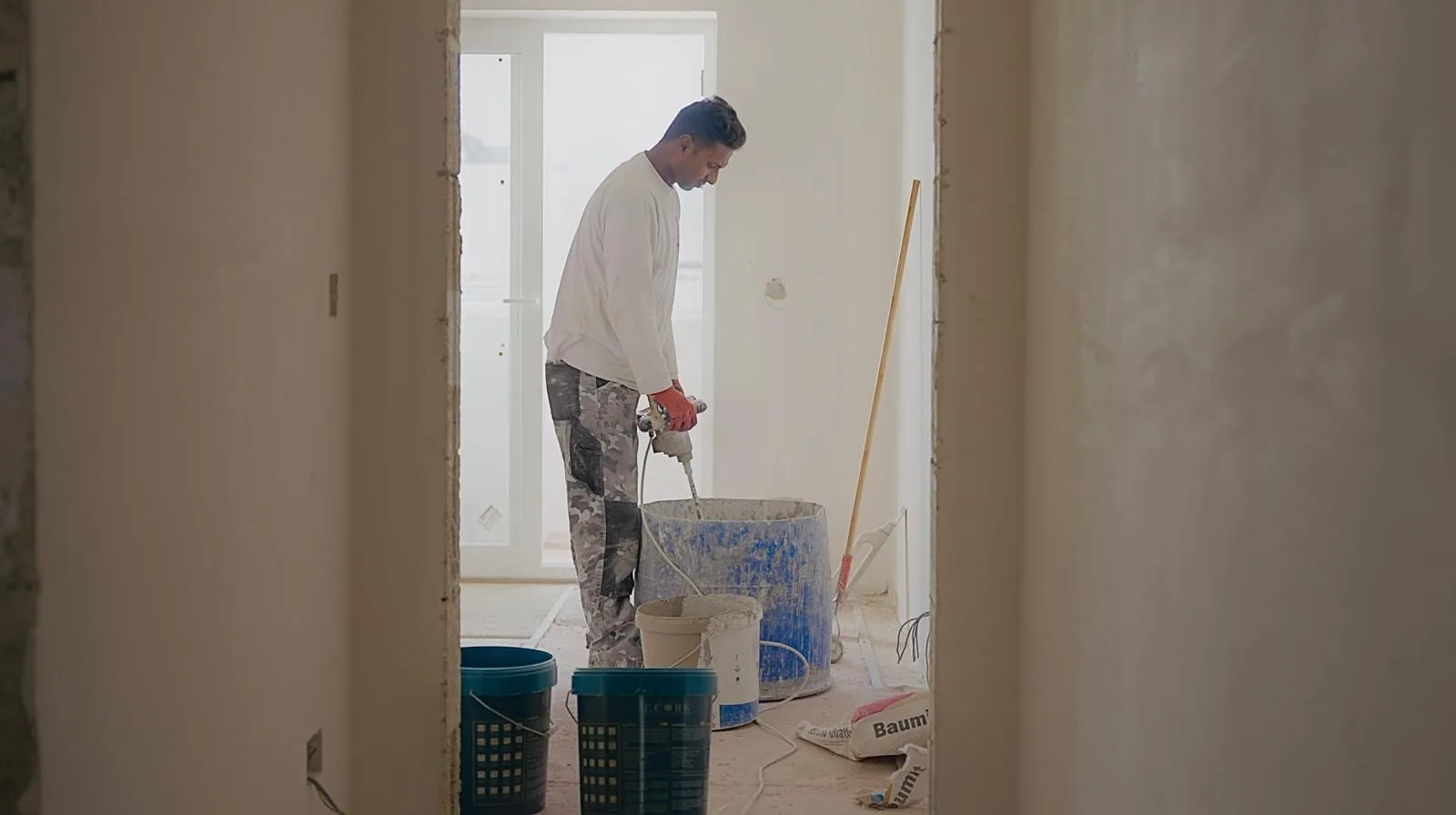 Plasterer preparing internal walls for a smooth finish