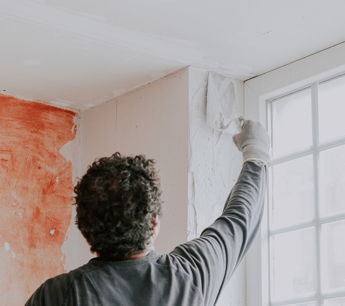 Plasterer finishing a wall corner in a Malta property