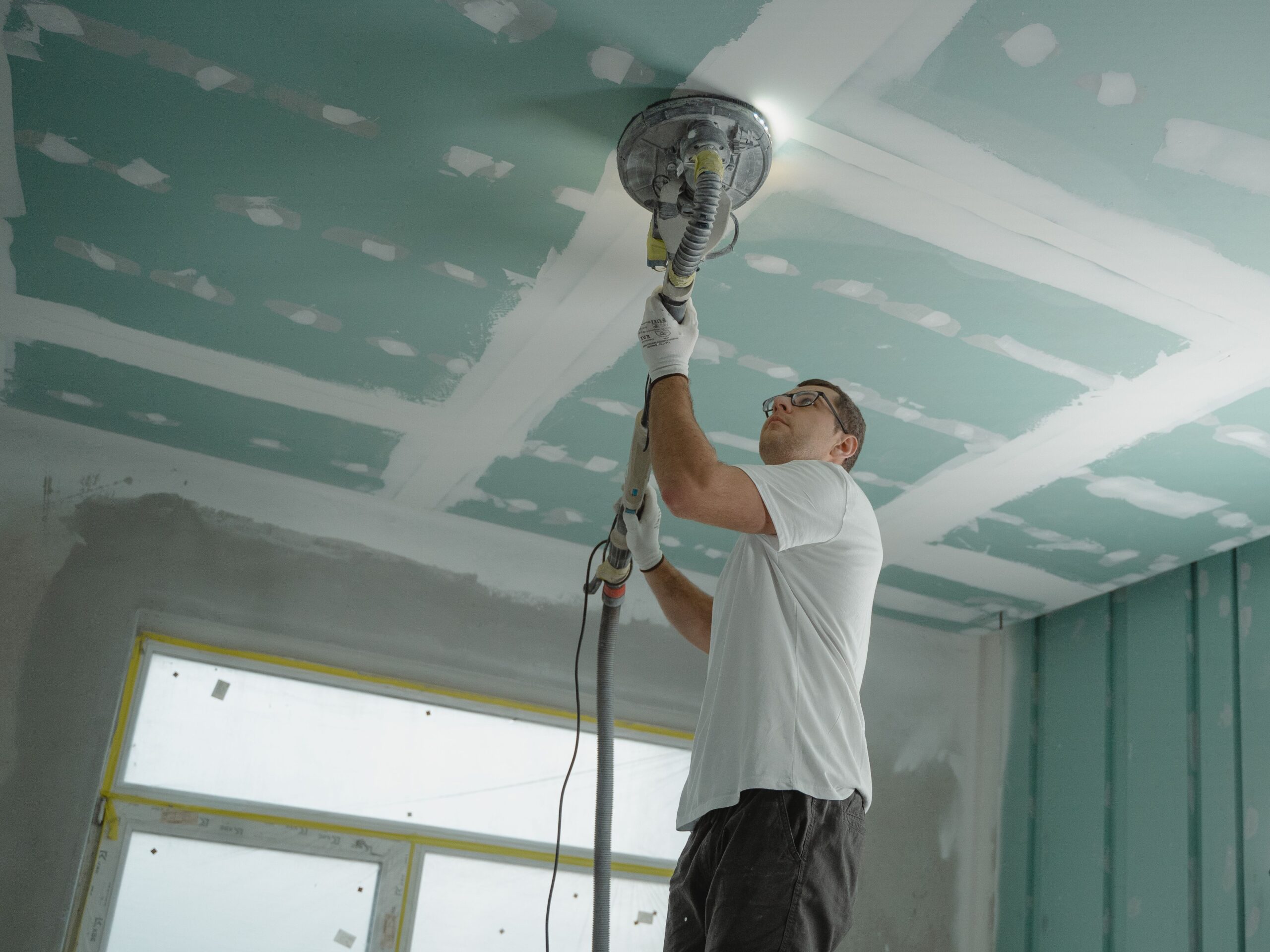 Gypsum partitions Malta ceiling being sanded and finished